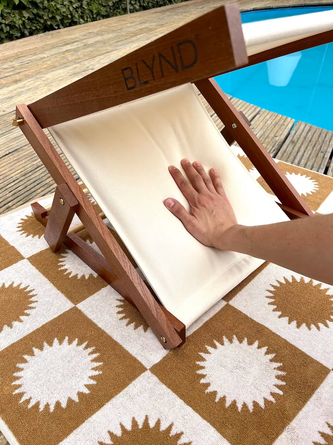 BLYND Premium Portable Beach Head Shade on towel with person pressing comfortable built-in pillow