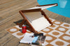 BLYND Premium Portable Beach Head Shade with can of soda, magazine, sunglasses, towel near swimming pool in the sun