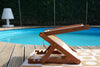 BLYND Premium Portable Beach Head Shade on towel near swimming pool wide shot within garden