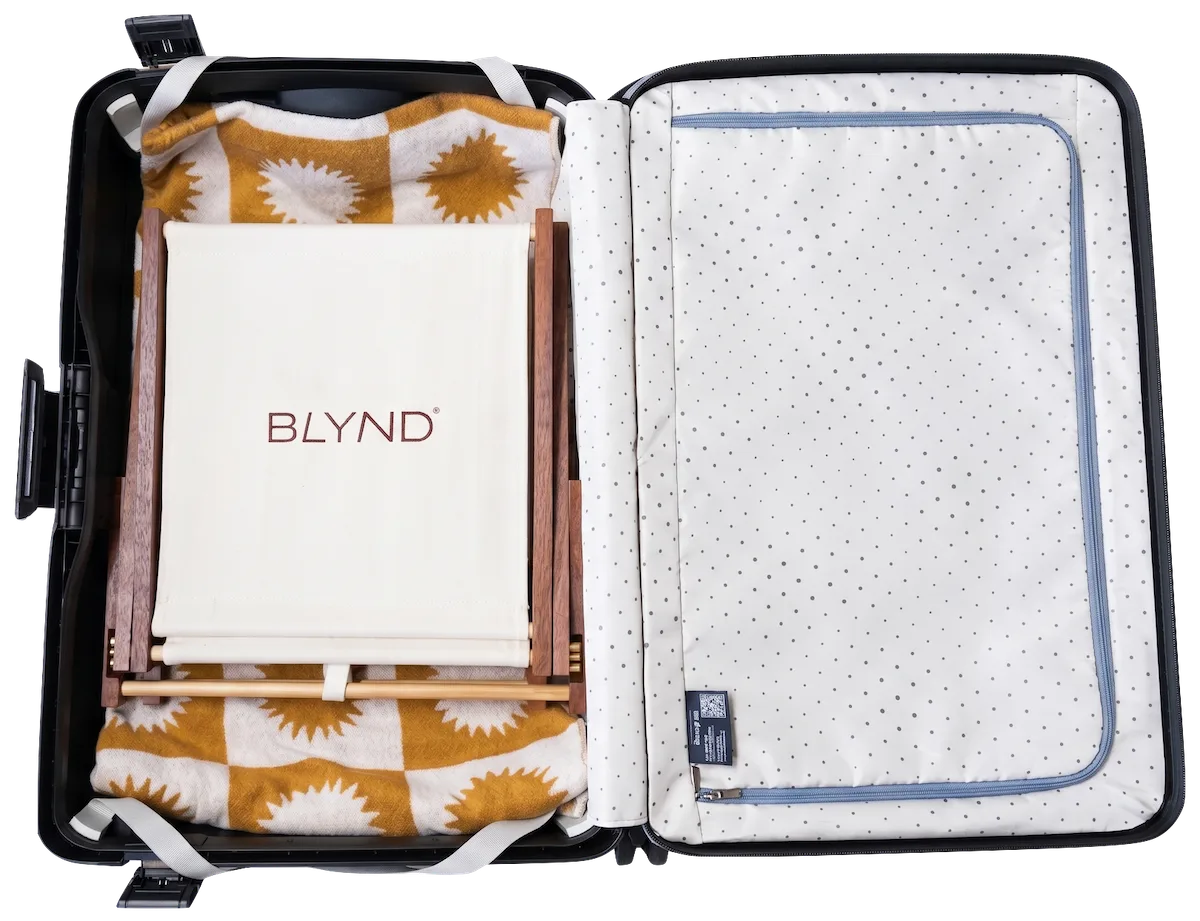 Open suitcase with BLYND Premium Portable Beach Head Shade easily fitted